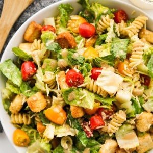 Caesar pasta salad in a bowl topped with croutons