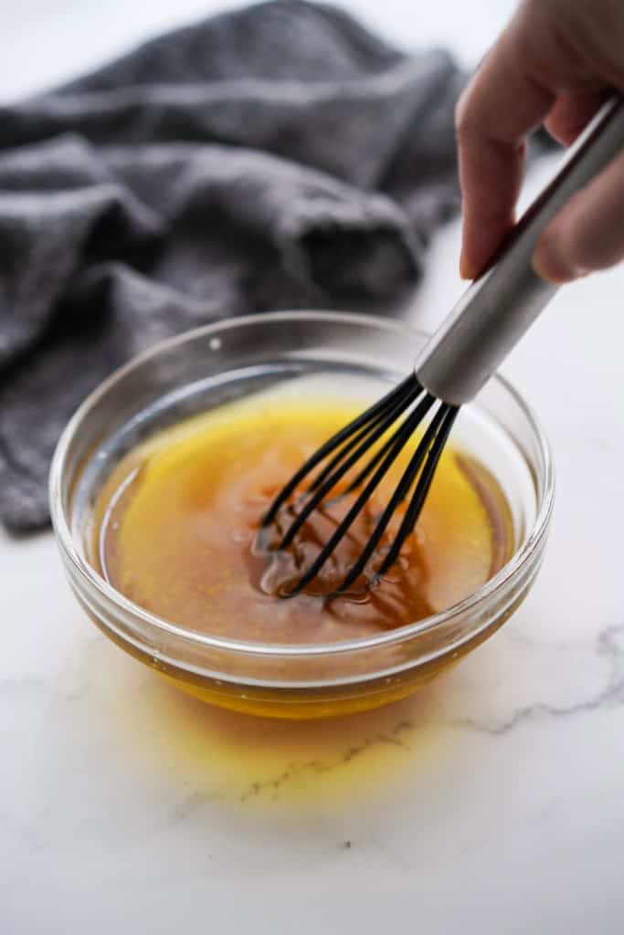 WHisking lemon maple dressing in a bowl