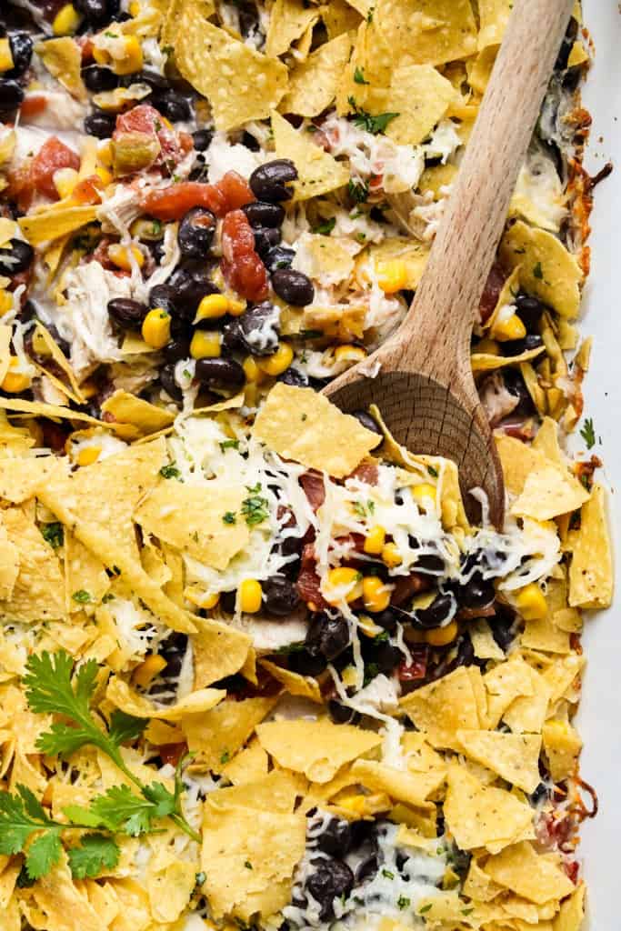 Digging into mexican chicken casserole topped with tortilla chips