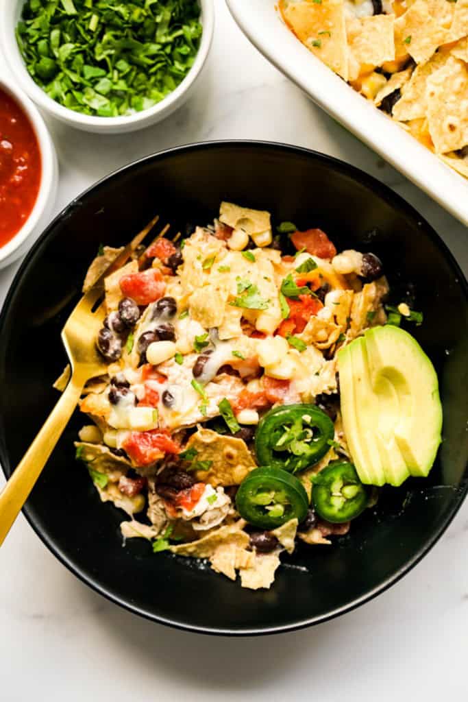 Top down view of a bowl of Mexican chicken combined with tomatoes, beans, avocados and jalapenos