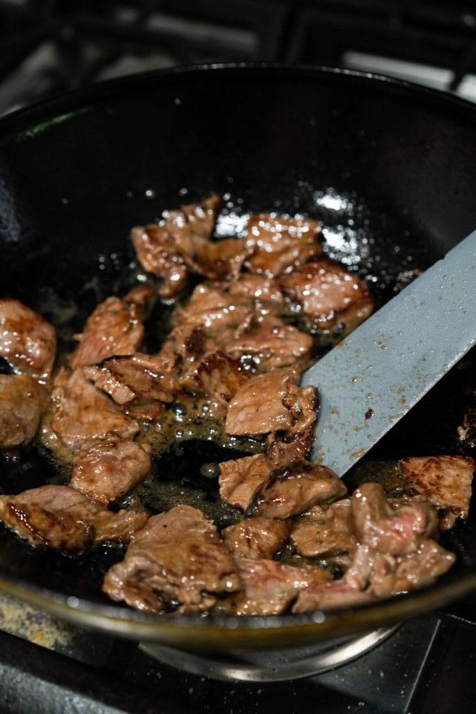 Saute-ing beef sirloin in pan