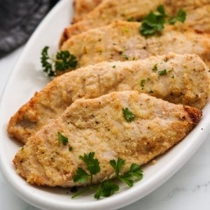 Thinly sliced chicken cutlets that are breaded and baked on a platter
