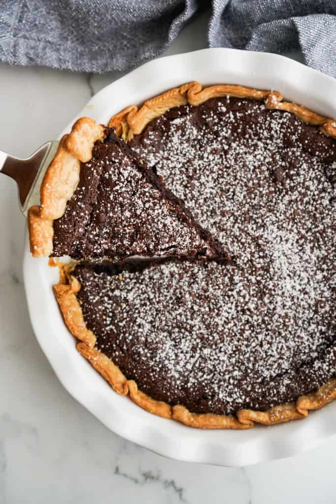 Top down view of a chocolate chess pie topped with powdered sugar