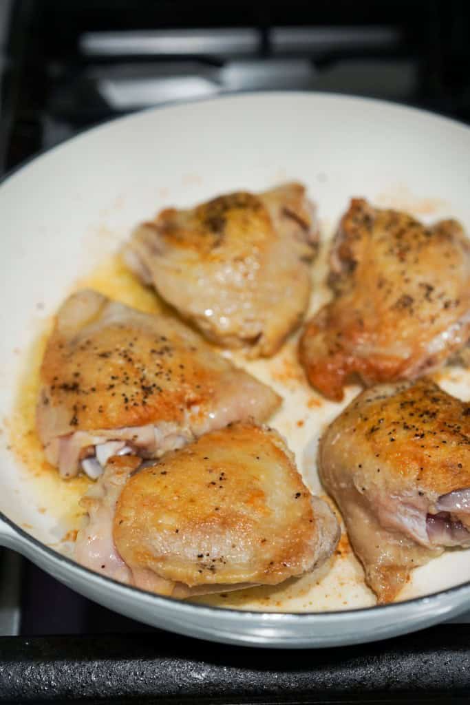 Searing skin on chicken thighs in a skillet