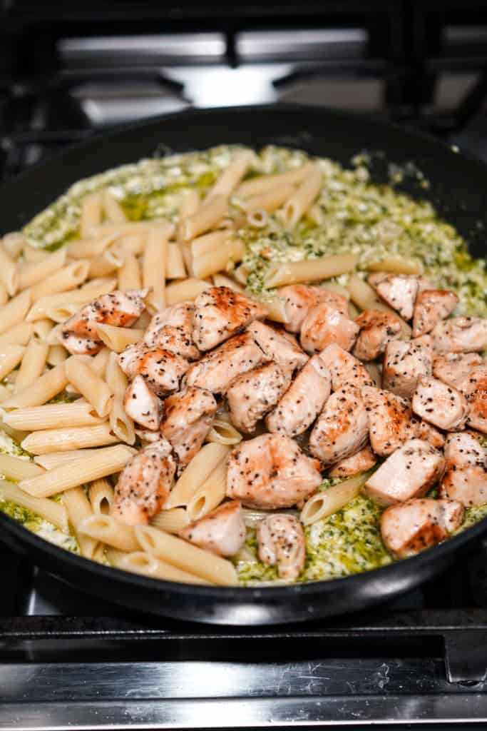 Penne and chicken pieces added to the creamy pesto sauce