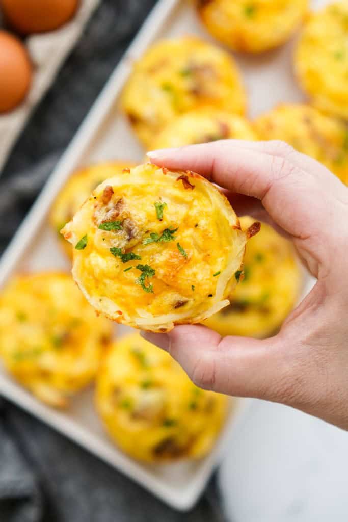 lifting up a egg bites with hashbrown at the bottom