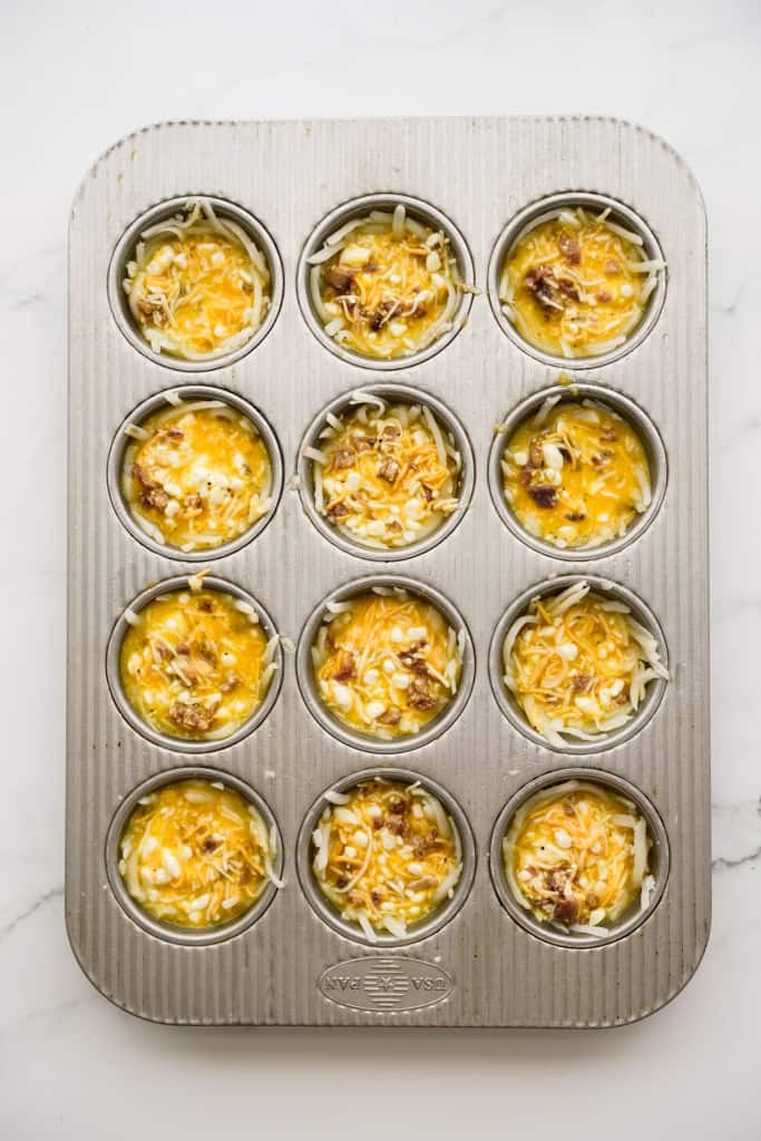 Shredded hash brown is lined in each muffin tin and top with egg mixture with bacon and cheese